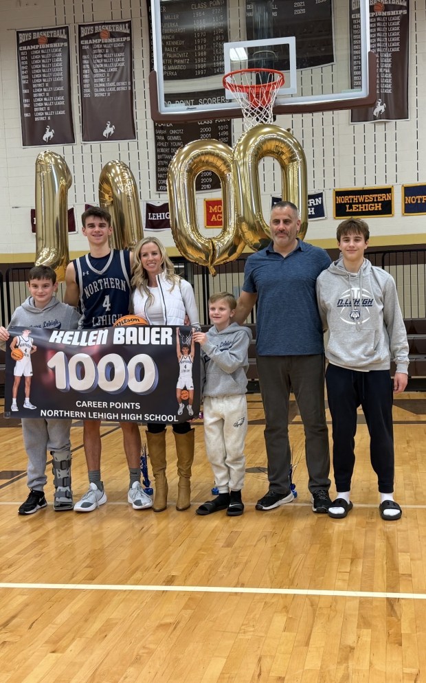 Northern Lehigh boys basketball player Kellen Bauer is surrounded by his family after scoring his 1,000th career point Tuesday night in a loss at Catasauqua. Bauer is the 12th boys player in school history to score 1,000 points. The Bauer family photo includes, left to right, Zach Bauer, Kellen Bauer, Kellen's mother Jackie Bauer, Cameron Bauer, Kellen's father Mike Bauer and teammate and brother Michael Bauer (Kim Popoff/Contributed photo)