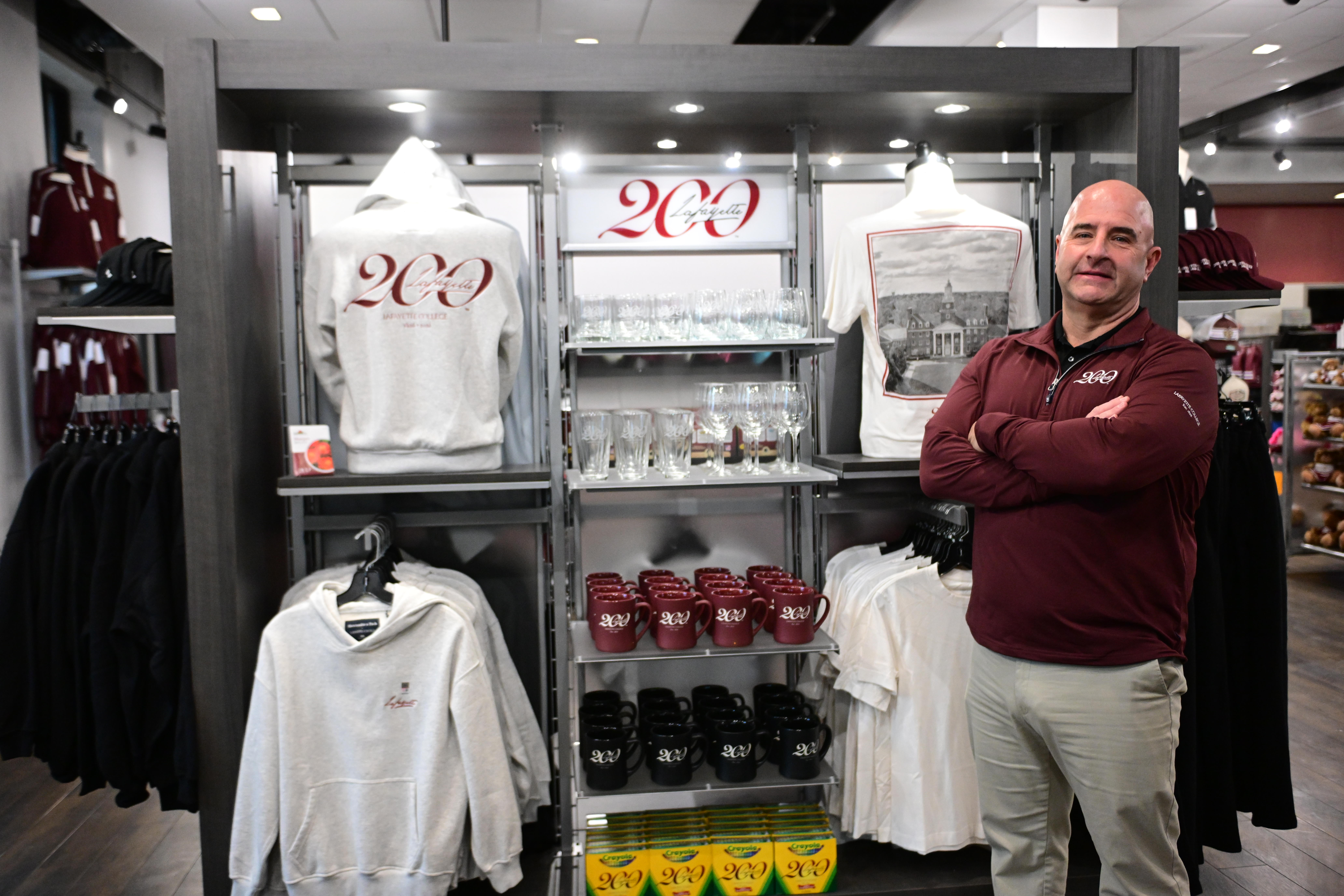 Lafayette College store manager Pete Violante arranges items Friday, Dec....