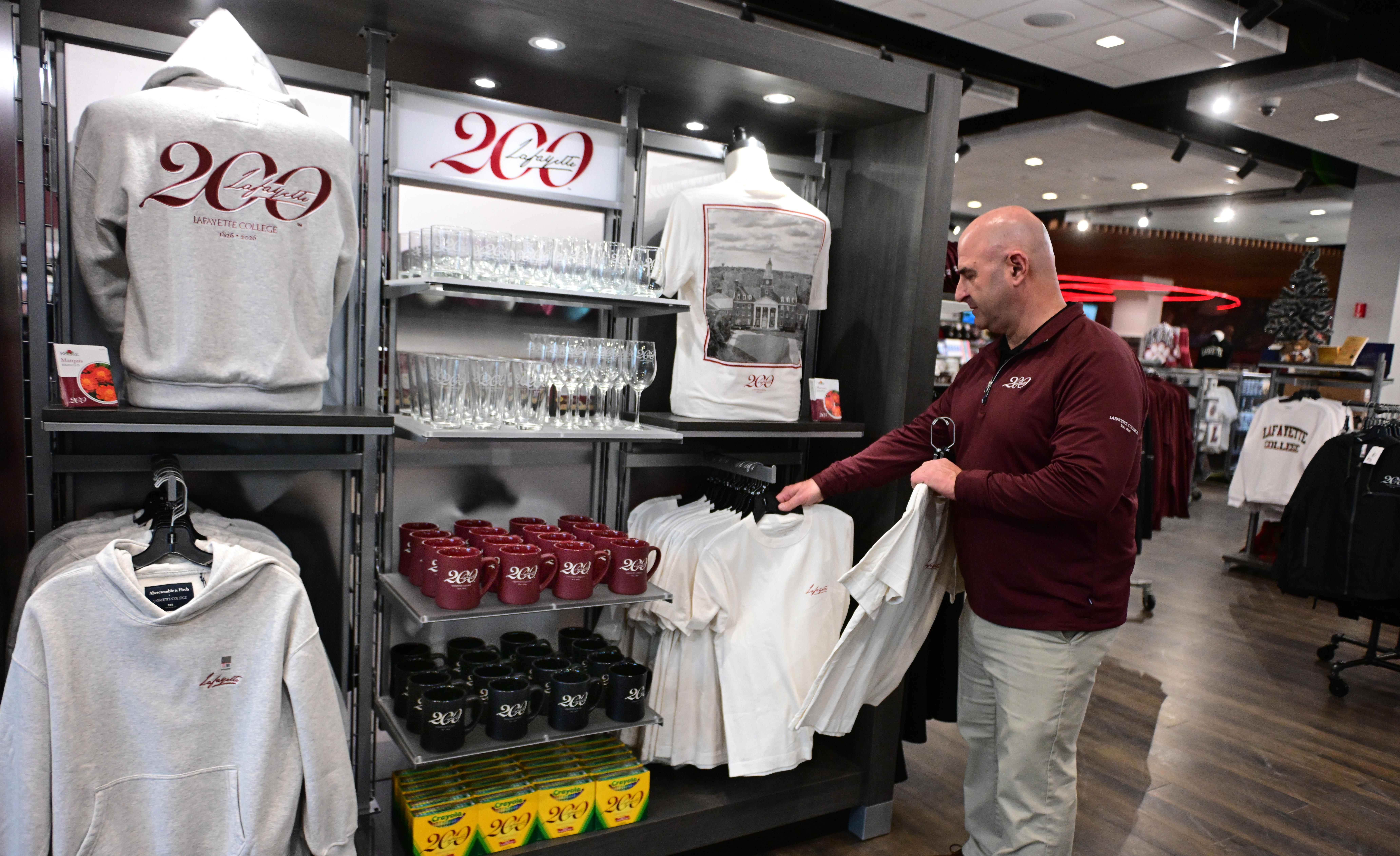 Lafayette College store manager Pete Violante arranges items Friday, Dec....