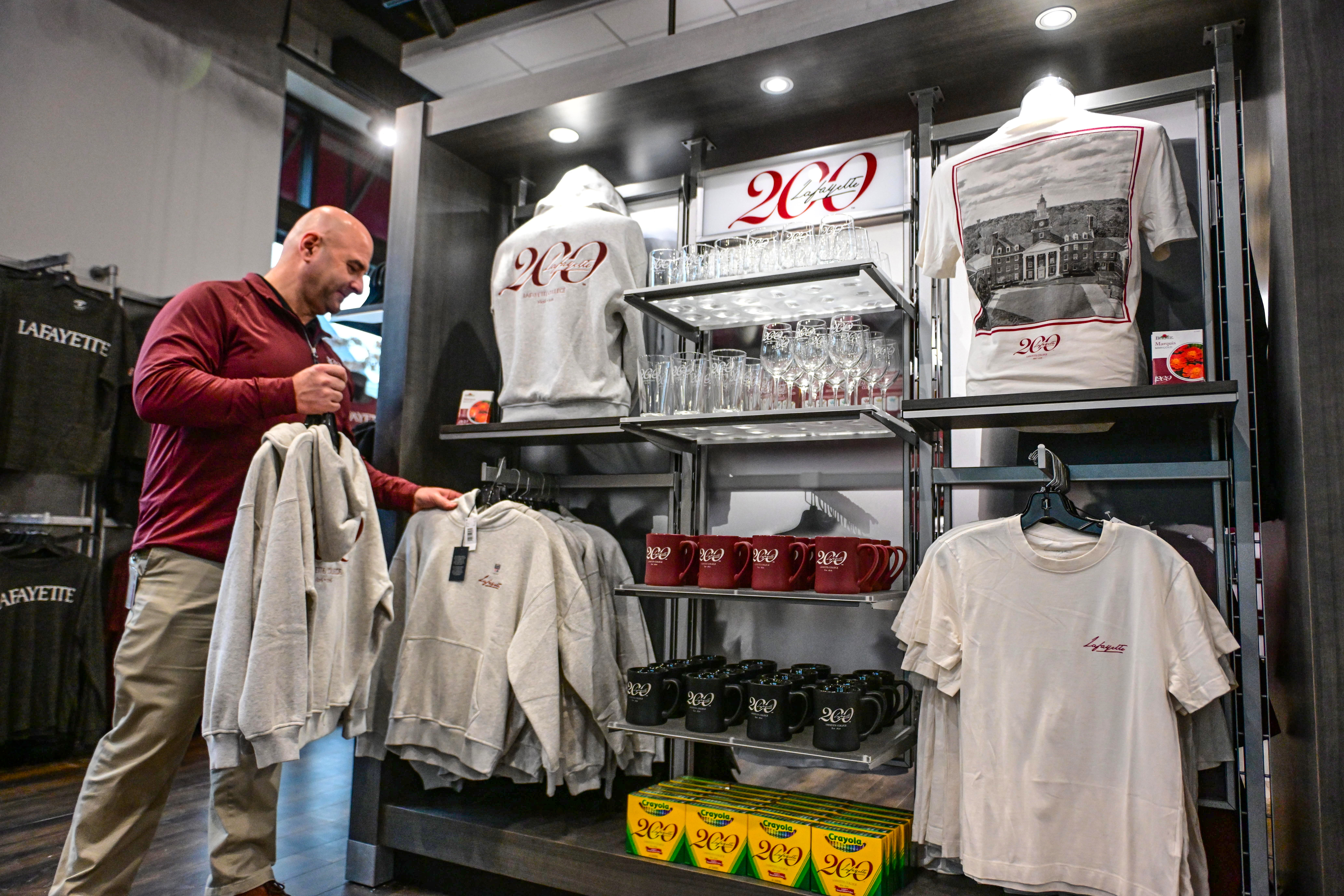 Lafayette College store manager Pete Violante arranges items Friday, Dec....