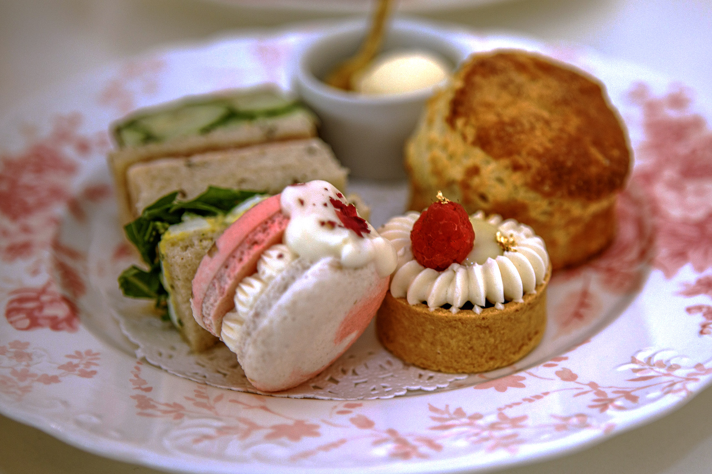 Two tea sandwiches, two desserts and a classic scone served...