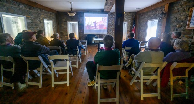 People watch videos featuring historic locations in Hellertown on Tuesday, Jan. 13, 2026, during Movies at the Mill at The Tavern Room in Hellertown. The six videos, made with a donation from the Martin Guitar Foundation, included ones about the Clock Tower, Stern's Market and The Sauconia/The Movies. A second set of six videos will debut at 6:30 p.m. Feb. 2 and 1 p.m. Feb. 3. (April Gamiz/The Morning Call)