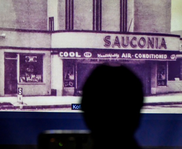 A person watches a video about the The Sauconia/The Movies on Tuesday, Jan. 13, 2026, during Movies at the Mill at The Tavern Room in Hellertown. Six videos featuring historic locations in Hellertown, made with a donation from the Martin Guitar Foundation, also included ones about the Clock Tower and Stern's Market. A second set of six videos will debut at 6:30 p.m. Feb. 2 and 1 p.m. Feb. 3. (April Gamiz/The Morning Call)