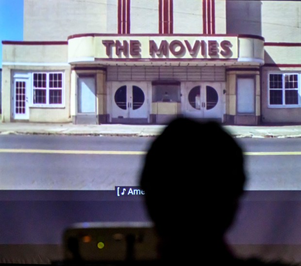 A person watches a video about the The Sauconia/The Movies on Tuesday, Jan. 13, 2026, during Movies at the Mill at The Tavern Room in Hellertown. Six videos featuring historic locations in Hellertown, made with a donation from the Martin Guitar Foundation, also included ones about the Clock Tower and Stern's Market. A second set of six videos will debut at 6:30 p.m. Feb. 2 and 1 p.m. Feb. 3. (April Gamiz/The Morning Call)
