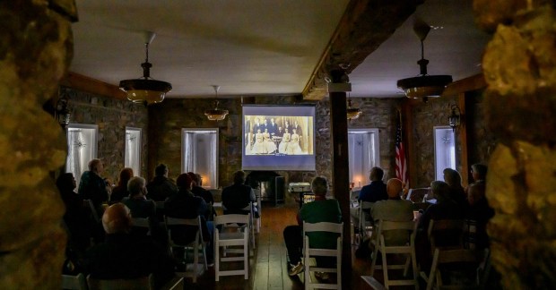 People watch videos featuring historic locations in Hellertown on Tuesday, Jan. 13, 2026, during Movies at the Mill at The Tavern Room in Hellertown. The six videos, made with a donation from the Martin Guitar Foundation, included ones about the Clock Tower, Stern's Market and The Sauconia/The Movies. A second set of six videos will debut at 6:30 p.m. Feb. 2 and 1 p.m. Feb. 3. (April Gamiz/The Morning Call)