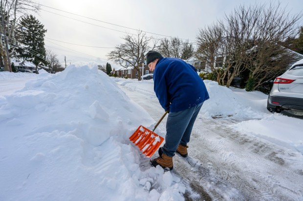 Donna Schuman of Bethlehem tries to shovel out her driveway Monday, Jan. 26, 2026, in Bethlehem after Sunday's storm that dropped more than a foot of snow in some parts of the Lehigh Valley. She said she shoveled yesterday as well to try and keep up with the storm. (April Gamiz/The Morning Call)