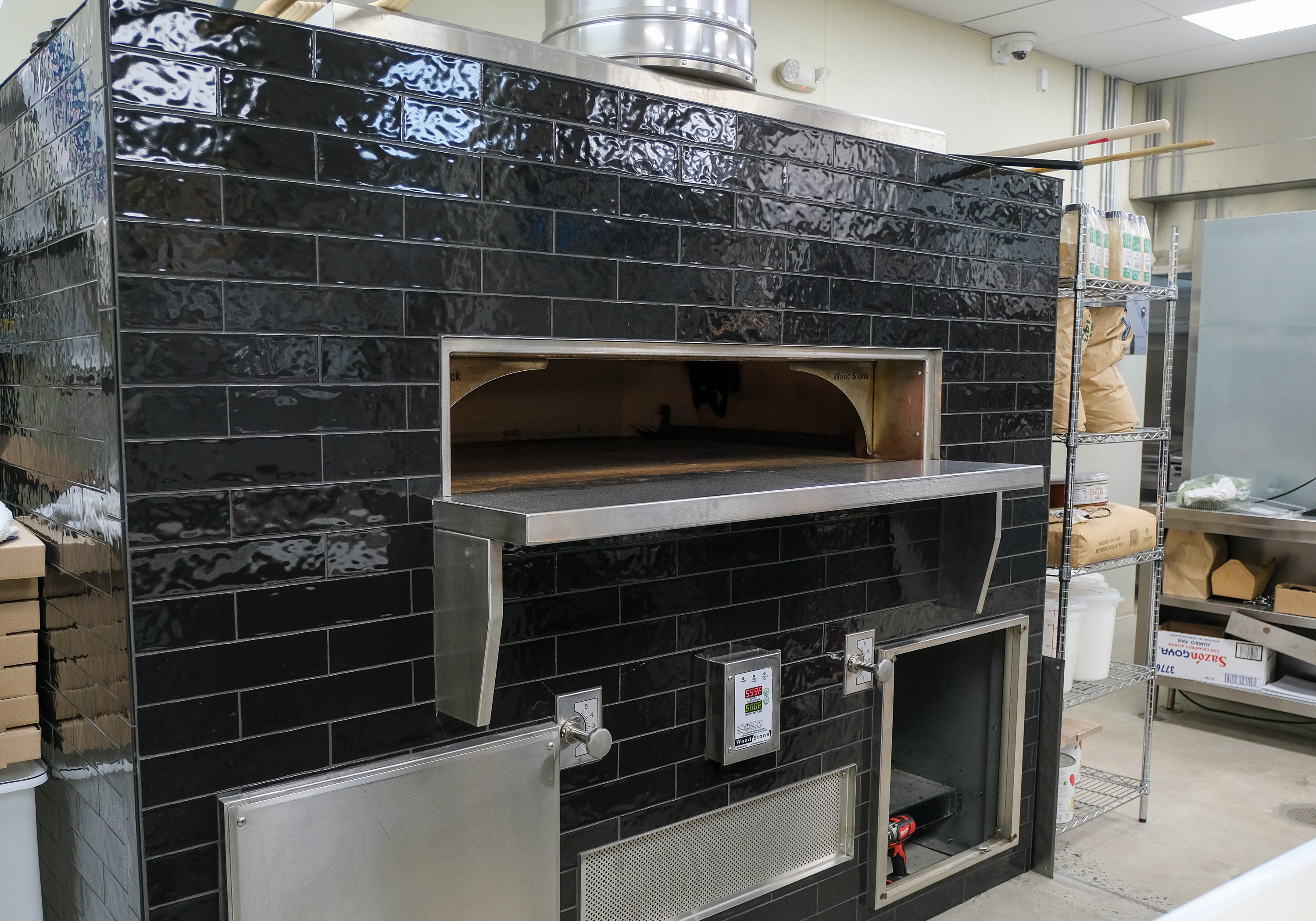 The Broken Record features a wood stone oven for preparing...