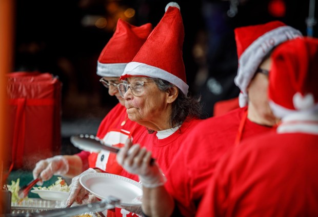 Volunteer "elves" from Holy Infancy Church in Bethlehem dish out food during the 14th annual Three Kings Celebration on Sunday, Jan. 4, 2026, at SteelStacks in Bethlehem. (Jane Therese/Special to The Morning Call)