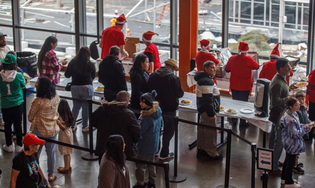 People wait in line for food during the 14th annual Three Kings Celebration on Sunday, Jan. 4, 2026, at SteelStacks in Bethlehem. (Jane Therese/Special to The Morning Call)