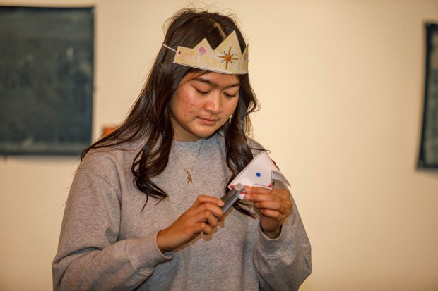 Dhanica Babelonia of Bethlehem helps to staple paper crowns together during the 14th annual Three Kings Celebration on Sunday, Jan. 4, 2026, at SteelStacks in Bethlehem. (Jane Therese/Special to The Morning Call)