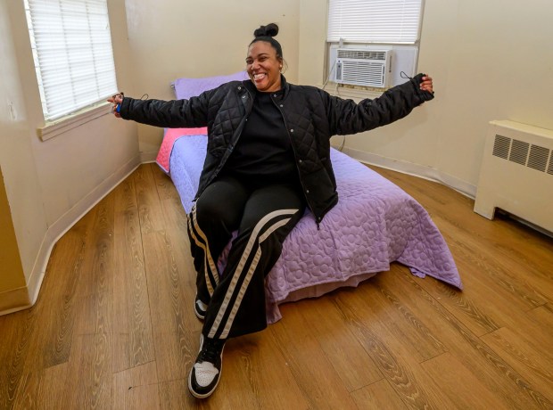 Amira Scott, a participant of the Step Up program, gives a tour Monday, Jan. 5, 2026, of her new Allentown apartment and reacts sitting on her bed in her own bedroom. She will share the apartment with her two young children. The Step Up program is a new, transitional housing program for families staying at the Sixth Street Shelter. Families can apply to stay in one of five apartments near the shelter, and will receive additional services to help them transition from shelter living to permanent housing, including case management and financial education. (April Gamiz / The Morning Call)