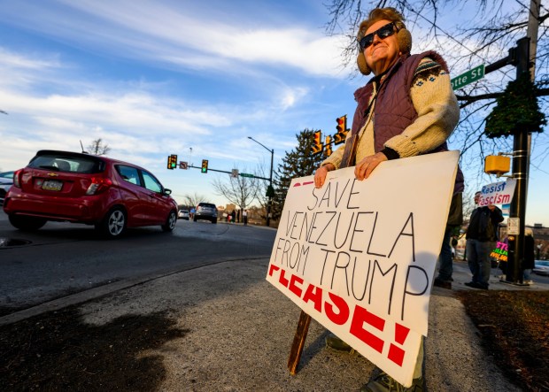 Nancy Tate of Riegelsville holds a sign as vehicles drive past Thursday, Jan. 8, 2026, in Bethlehem. Organizers with the Lehigh Valley Democratic Socialists of America and LEPOCO Peace Center protest for causes including against the recent U.S. military action in Venezuela. (April Gamiz/The Morning Call)