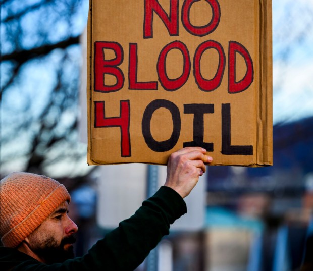 Anton Shannon of Nazareth holds a sign as vehicles drive past Thursday, Jan. 8, 2026, in Bethlehem. Organizers with the Lehigh Valley Democratic Socialists of America and LEPOCO Peace Center protest for causes including against the recent U.S. military action in Venezuela. (April Gamiz/The Morning Call)