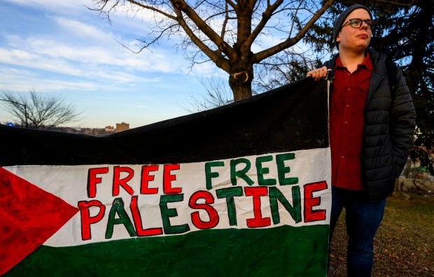 Leo Atkinson, co-chair of Lehigh Valley Democratic Socialists of America, holds a banner Thursday, Jan. 8, 2026, in Bethlehem. Organizers with the Lehigh Valley Democratic Socialists of America and LEPOCO Peace Center protest for causes including against the recent U.S. military action in Venezuela. (April Gamiz/The Morning Call)