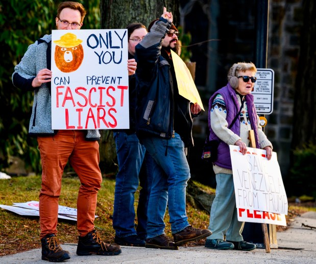 Protesters hold signs as vehicles drive past Thursday, Jan. 8, 2026, in Bethlehem. Organizers with the Lehigh Valley Democratic Socialists of America and LEPOCO Peace Center protest for causes including against the recent U.S. military action in Venezuela. (April Gamiz/The Morning Call)