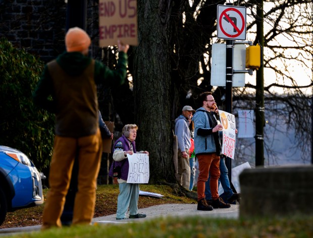 Nancy Tate of Riegelsville holds a sign with others as vehicles drive past Thursday, Jan. 8, 2026, in Bethlehem. Organizers with the Lehigh Valley Democratic Socialists of America and LEPOCO Peace Center protest for causes including against the recent U.S. military action in Venezuela. (April Gamiz/The Morning Call)