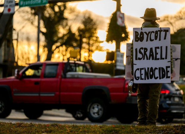 Protesters hold signs as vehicles drive past Thursday, Jan. 8, 2026, in Bethlehem. Organizers with the Lehigh Valley Democratic Socialists of America and LEPOCO Peace Center protest for causes including against the recent U.S. military action in Venezuela. (April Gamiz/The Morning Call)