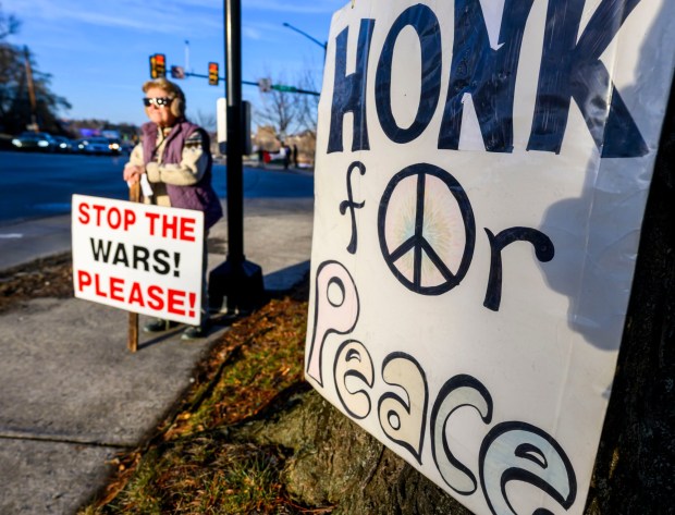 Nancy Tate of Riegelsville holds a sign as vehicles drive past Thursday, Jan. 8, 2026, in Bethlehem. Organizers with the Lehigh Valley Democratic Socialists of America and LEPOCO Peace Center protest for causes including against the recent U.S. military action in Venezuela. (April Gamiz/The Morning Call)