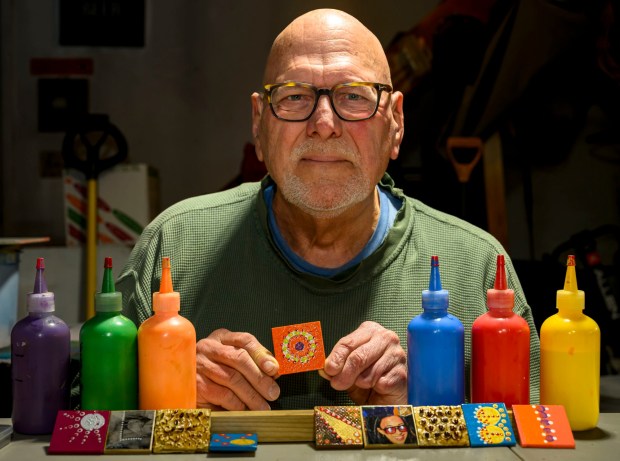 Dave Jacoby of Bethlehem Township creates experimental art on tiles with magnets Tuesday, Jan. 6, 2026, in Bethlehem Township. As part of an idea he had years ago that he calls WOA! (World of art!), Jacoby leaves the tiles in various place to cheer up people at a time when there is fear, anger and sadness in the world. He started a Facebook page and gives the tiles to people, asking them to spread the art and upload a photo and a post about where it was placed. (April Gamiz / The Morning Call)