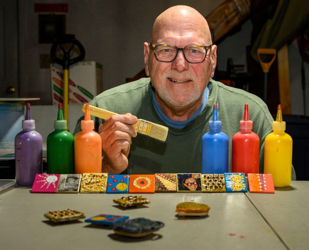 Dave Jacoby of Bethlehem Township creates experimental art on tiles with magnets Tuesday, Jan. 6, 2026, in Bethlehem Township. As part of an idea he had years ago that he calls WOA! (World of art!), Jacoby leaves the tiles in various place to cheer up people at a time when there is fear, anger and sadness in the world. He started a Facebook page and gives the tiles to people, asking them to spread the art and upload a photo and a post about where it was placed. (April Gamiz / The Morning Call)