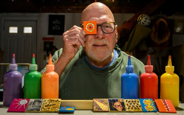 Dave Jacoby of Bethlehem Township creates experimental art on tiles with magnets Tuesday, Jan. 6, 2026, in Bethlehem Township. As part of an idea he had years ago that he calls WOA! (World of art!), Jacoby leaves the tiles in various place to cheer up people at a time when there is fear, anger and sadness in the world. He started a Facebook page and gives the tiles to people, asking them to spread the art and upload a photo and a post about where it was placed. (April Gamiz / The Morning Call)