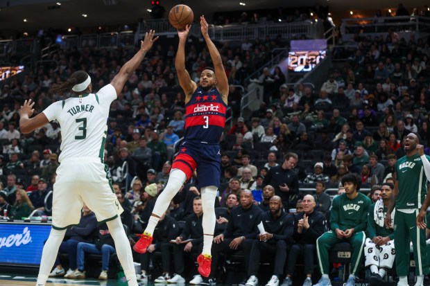 Washington Wizards' CJ McCollum, a Lehigh graduate, shoots over Milwaukee Bucks' Myles Turner during the second half, Wednesday, Dec. 31, 2025, in Milwaukee. (AP Photo/Kylie Bridenhagen)