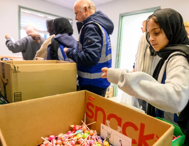 Ayala Moti and other members of the Ahmadiyya Muslim Community's Lehigh Valley chapter gather to pack essential supply kits for individuals experiencing homelessness Sunday, Jan. 11, 2026, at Baitul Ata Mosque in Salisbury Township. The effort is part of the community's ongoing commitment to its guiding principle, "Love for All, Hatred for None," which includes regular blood drives, food drives and programs to feed the hungry throughout the year. (April Gamiz/The Morning Call)