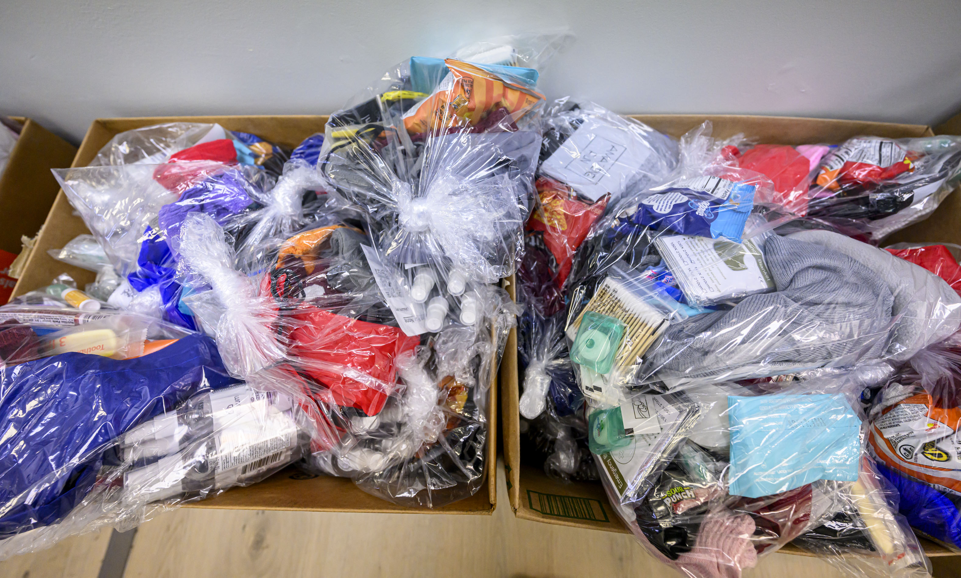 Around 120 essential supply kits containing water, hand warmers, a...