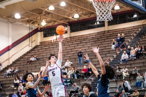 Liberty's Jake Pukszyn takes a shot while Pocono Mountain West's Teddy Stiehler defends during an Eastern Pennsylvania Conference basketball game on Thursday, Dec.18, 2025, at Liberty High School in Bethlehem. (Jonathan Broady/Special to The Morning Call)