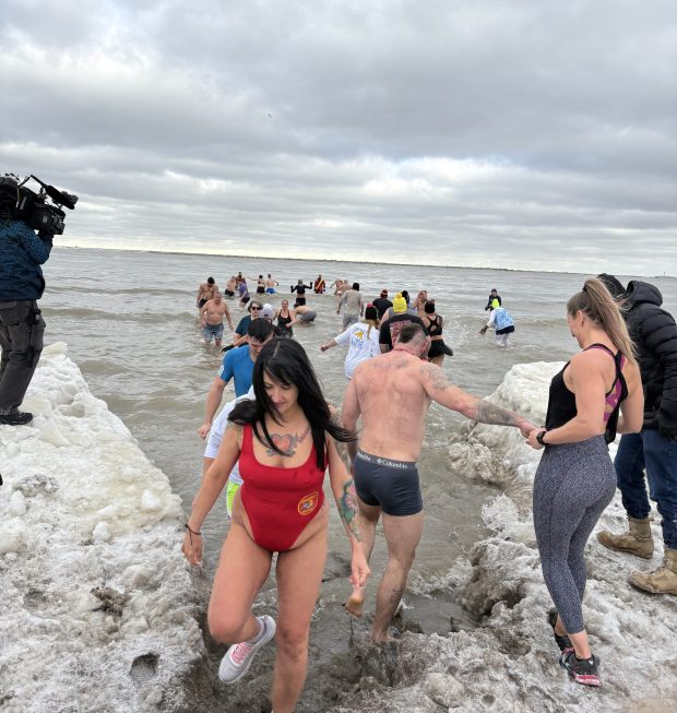 Hundreds of people rang in New Year's Day by taking the 'Port Plunge at Fairport Harbor Lakefront Beach on Jan. 1. (William Tilton - News-Herald)