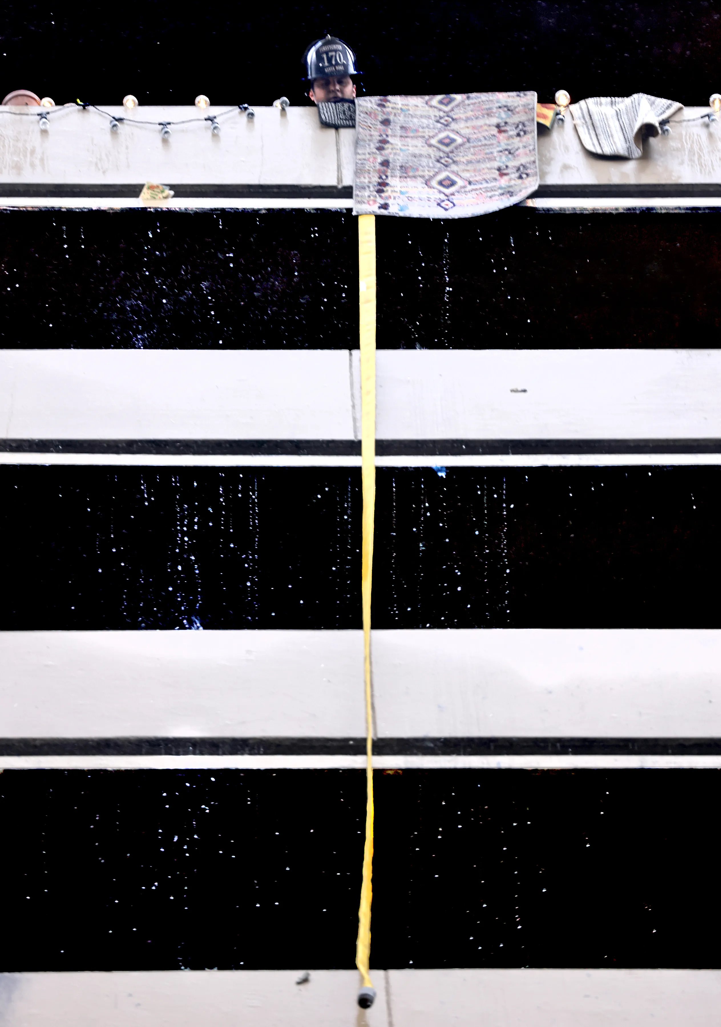 A fire hose is extended from the 12th floor of...