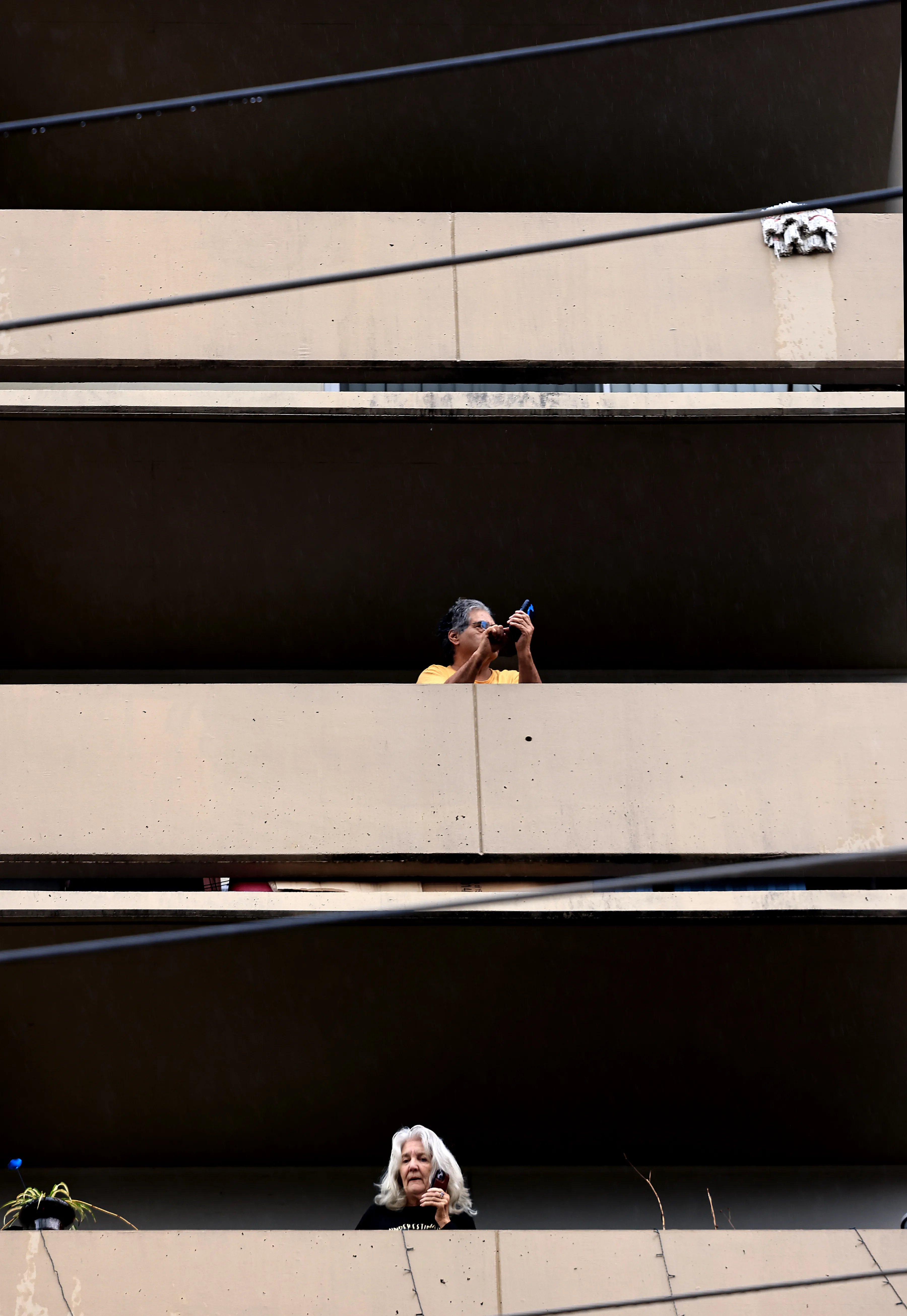Residents of Bethlehem Towerâs south side watch as firefighters pull...
