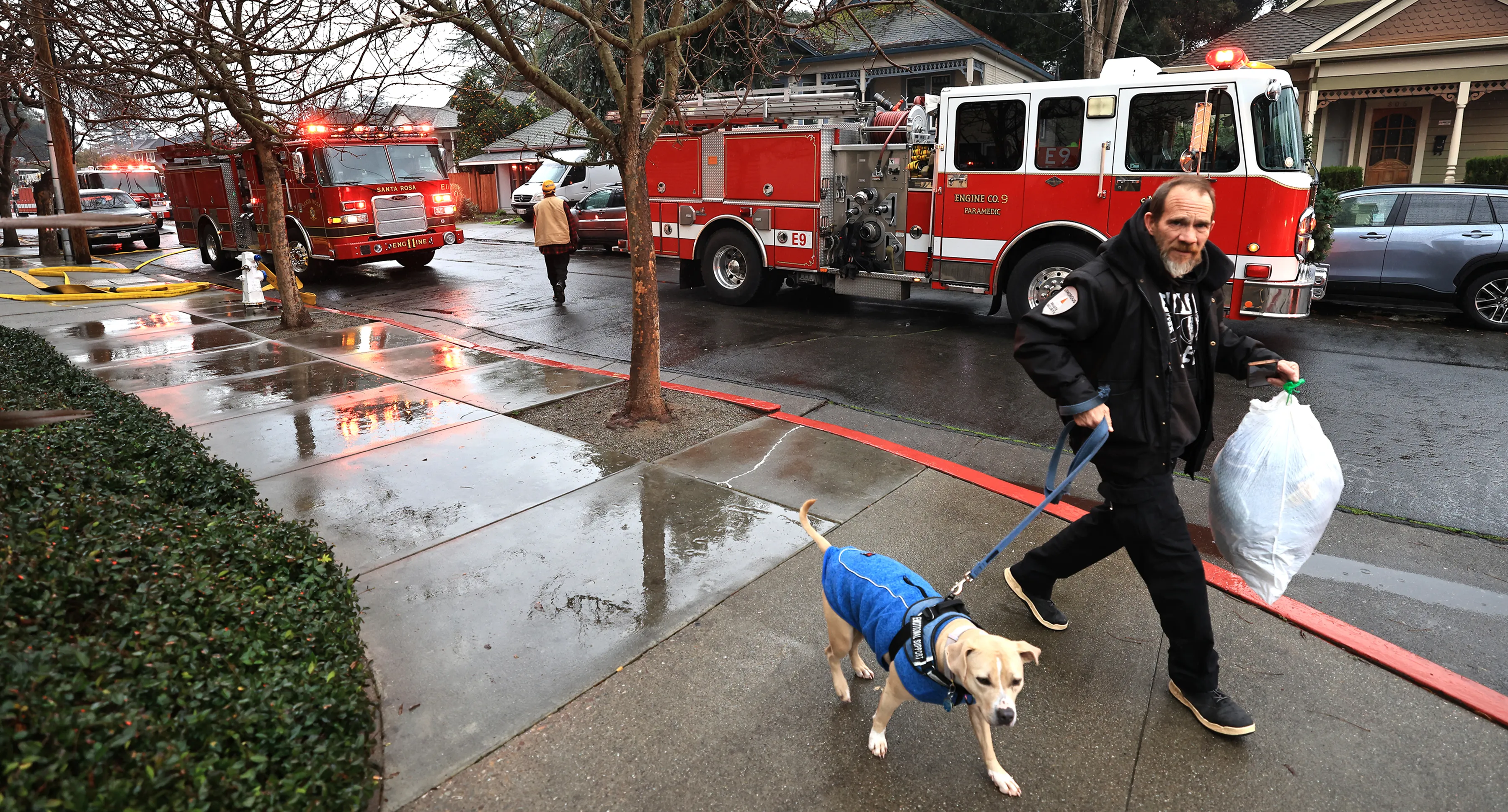 A resident of Bethlehem Tower evacuates after an apartment caught...
