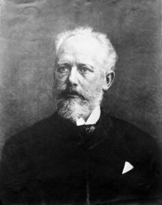 A black and white archival photo of Pyotr Ilich Tchaikovsky
