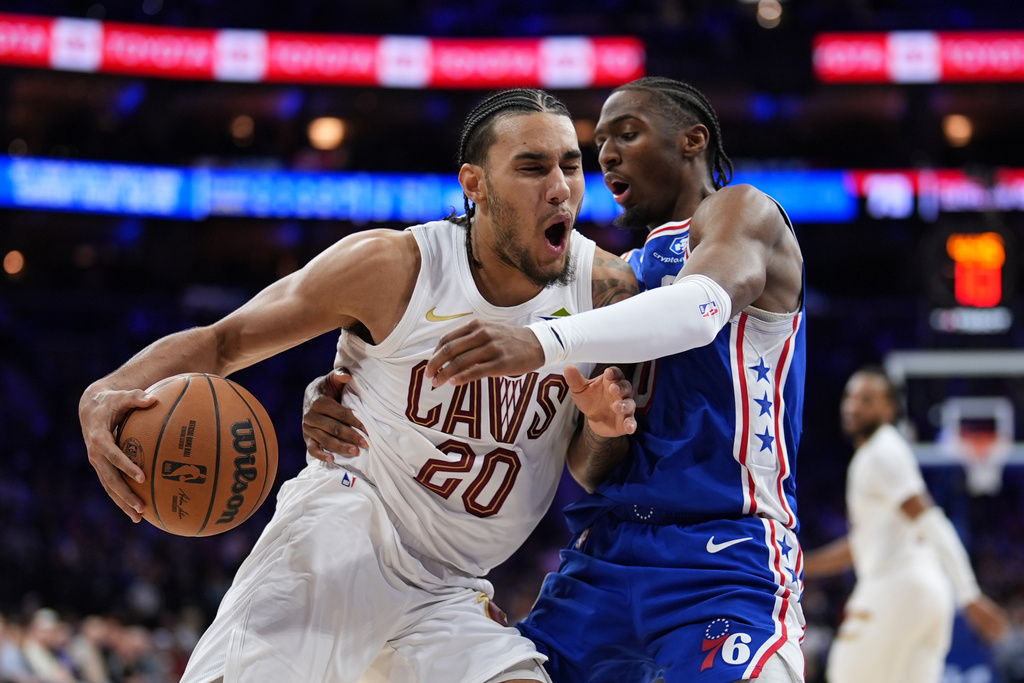 Cleveland Cavaliers' Jaylon Tyson, left, tries to get past Philadelphia 76ers' Tyrese Maxey during the second half of an NBA basketball game Wednesday, Jan. 14, 2026, in Philadelphia.