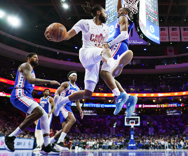 Cleveland Cavaliers' Darius Garland, left, passes against Philadelphia 76ers' Tyrese Maxey during the first half of an NBA basketball game Wednesday, Jan. 14, 2026, in Philadelphia. 