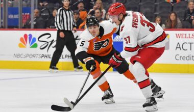 Oct 30, 2023; Philadelphia, Pennsylvania, USA; Philadelphia Flyers defenseman Egor Zamula (5) and Carolina Hurricanes right wing Andrei Svechnikov (37) battle for the puck during the third period at Wells Fargo Center.