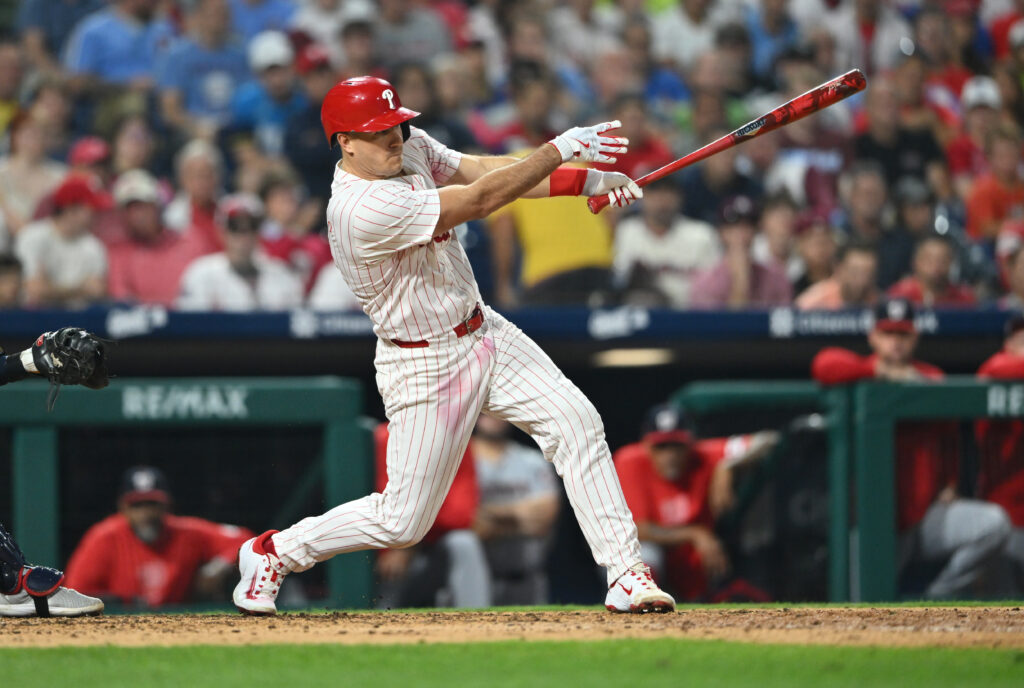 Aug 17, 2024; Philadelphia, Pennsylvania, USA; Philadelphia Phillies catcher J.T. Realmuto (10) hits an RBI single against the Washington Nationals in the sixth inning at Citizens Bank Park.