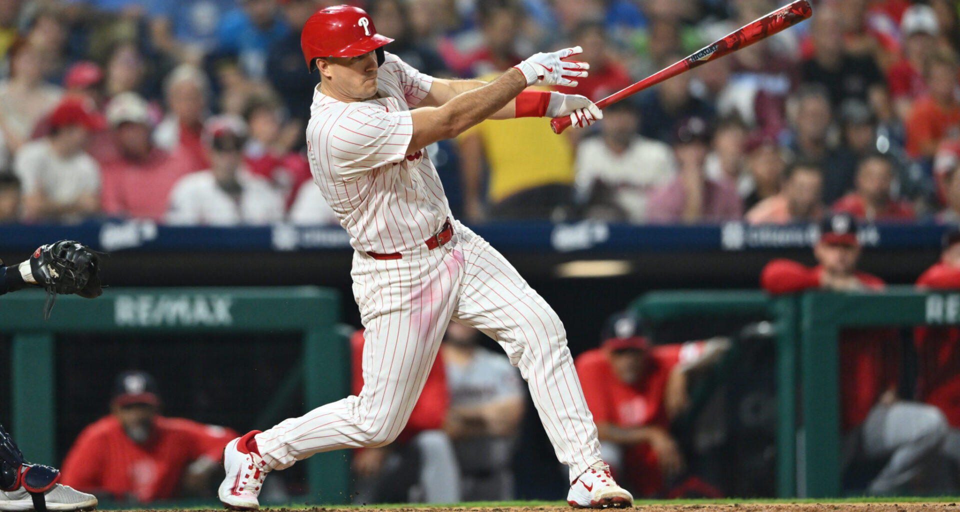 Aug 17, 2024; Philadelphia, Pennsylvania, USA; Philadelphia Phillies catcher J.T. Realmuto (10) hits an RBI single against the Washington Nationals in the sixth inning at Citizens Bank Park.