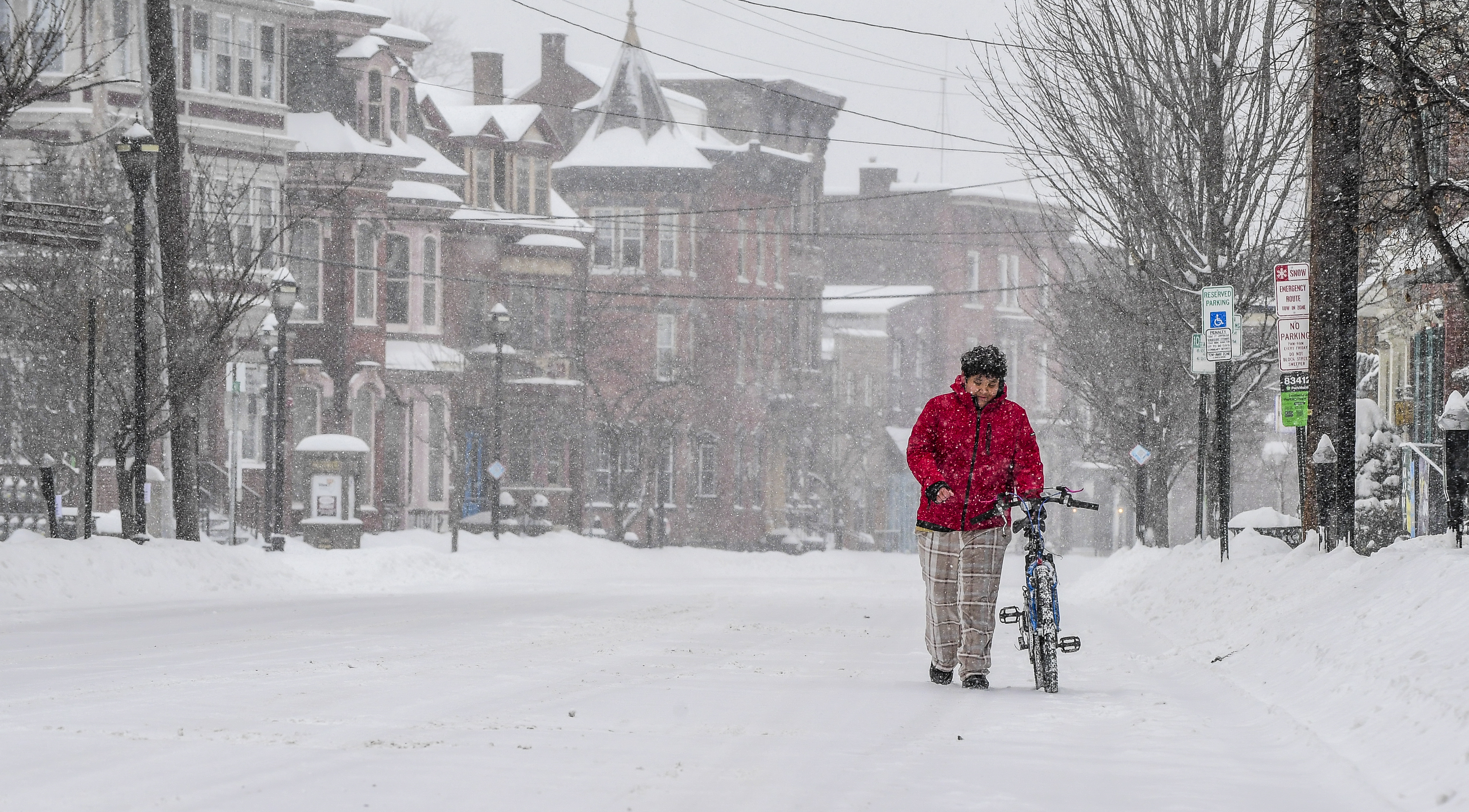 Immer Segovia, 12, of Phillipsburg, walks his bicycle in the 100 block of South Main St, Phillipsburg about 1:15 pm, Jan. 25, 2026 as snow of the first major snow storm bankets the Lehigh Valley.