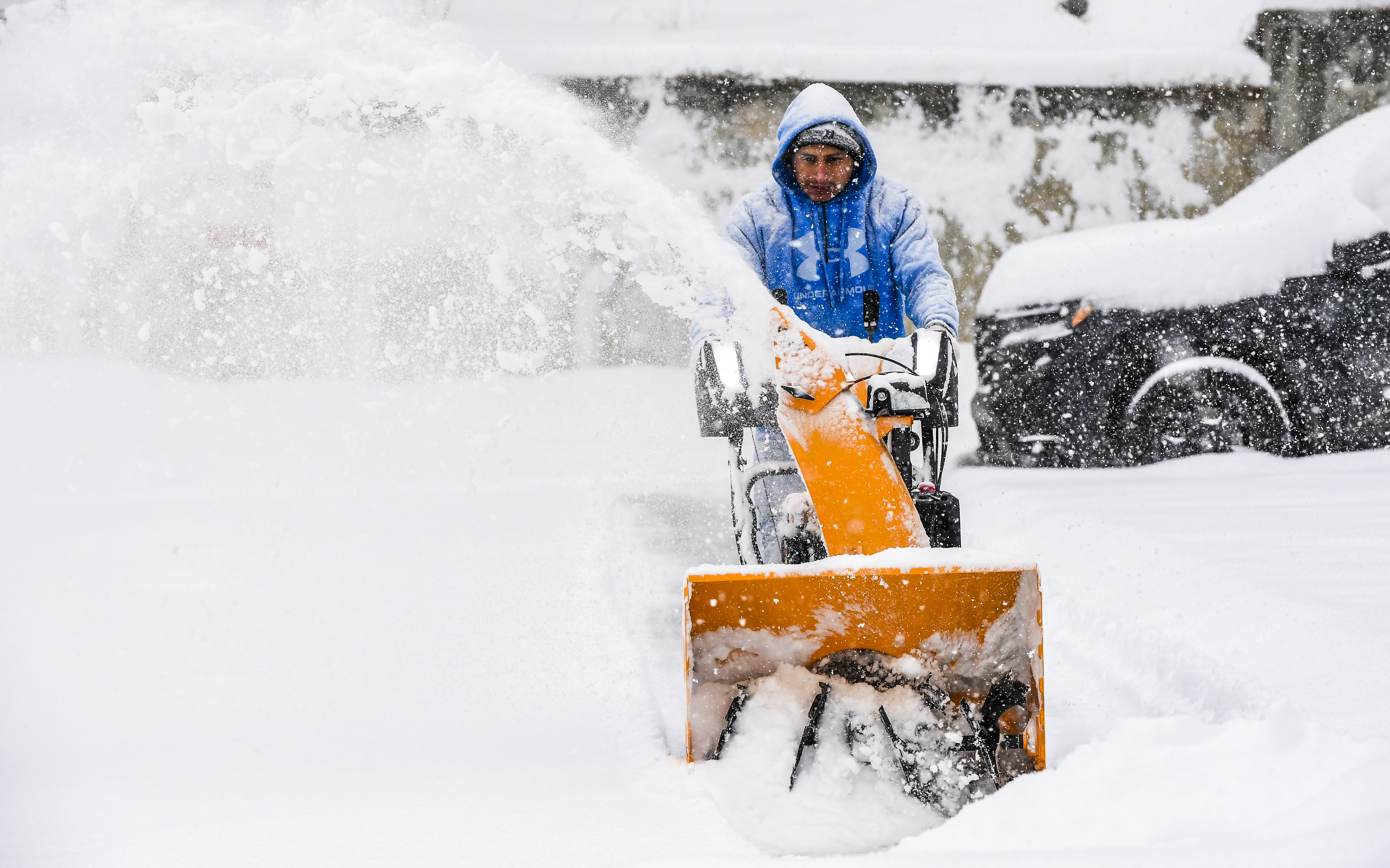 Orlando Longo uses a snowblower in the parking lot of The Elks Building just after 1:00 pm, Jan. 25, 2026.