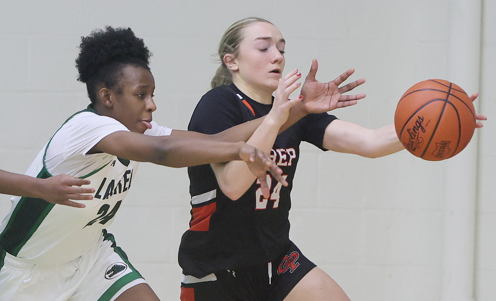 Laurel's Tristan Williams (L) knocks a pass away from Cathedral Prep's Mia Washburn for a turnover in the second half. 