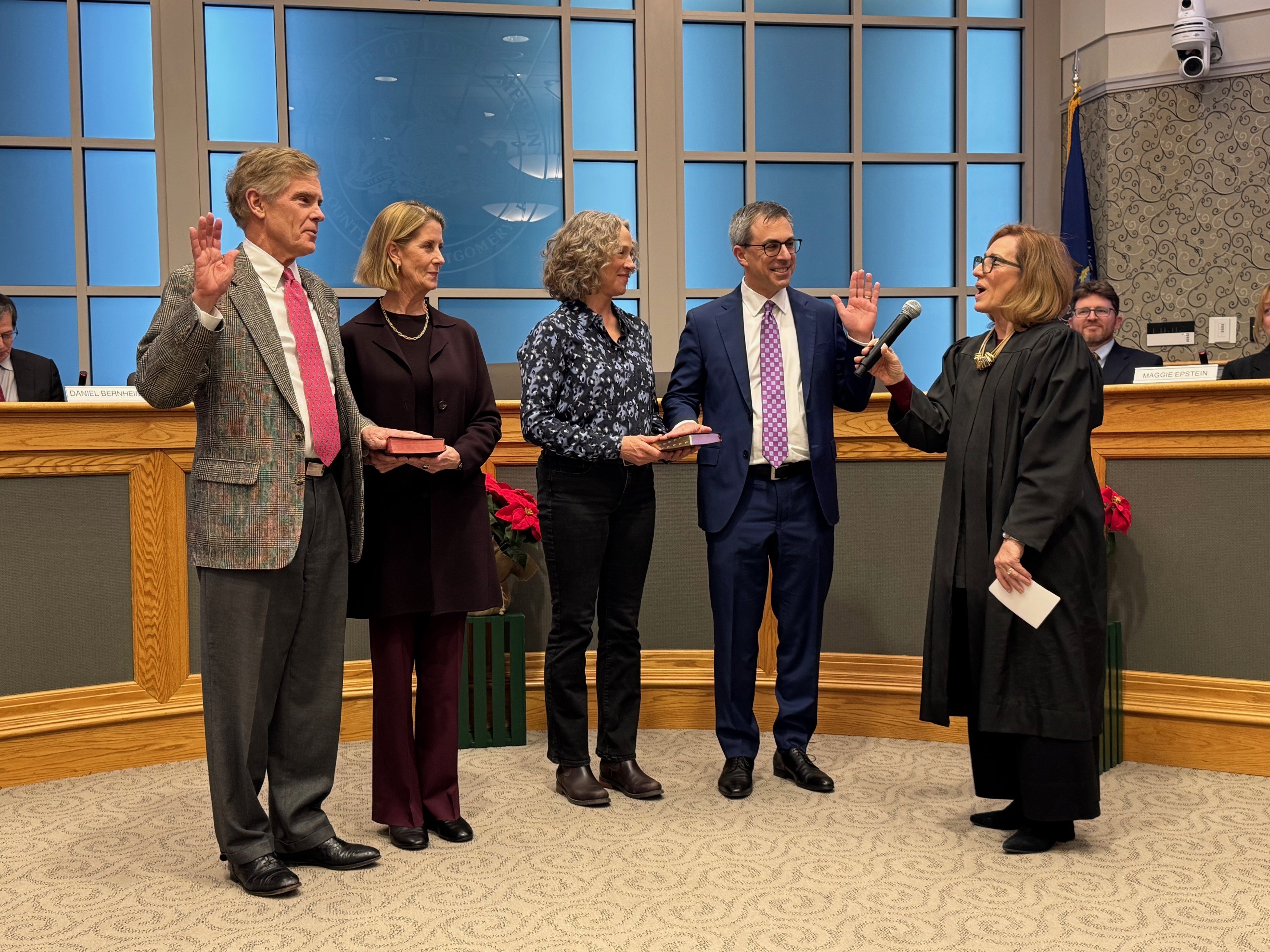 Reelected commissioners Scott Zelov and Todd Sinai being sworn for...