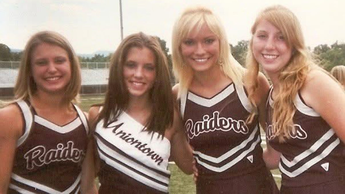 Caitlin O'Connor in a cheerleading uniform with her friends.
