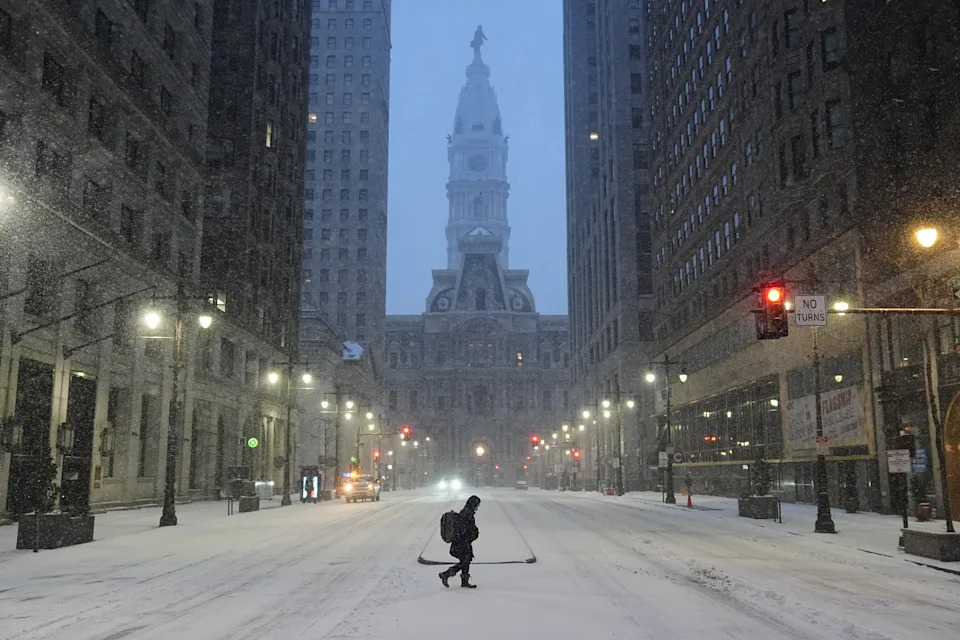 A person walks across a street during a winter storm in Philadelphia on Jan. 25, 2026. 