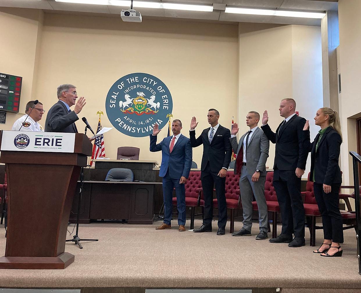 Erie Mayor Joe Schember swears in, from left, Ryan VanTassel, Erich Semelka, Denis Kohanevich, James Williams and Jessica Dahlstrand as the newest members of the Erie Bureau of Police during a ceremony at Erie City Hall on Friday.