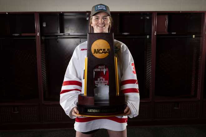 MINNEAPOLIS, MINNESOTA - MARCH 23: Ava McNaughton #30 of the Wisconsin Badgers poses with the trophy after winning the Division I Women's Ice Hockey Championship game against the Ohio State Buckeyes held at Ridder Arena on March 23, 2025 in Minneapolis, Minnesota. (Photo by Carlos Gonzalez/NCAA Photos via Getty Images)