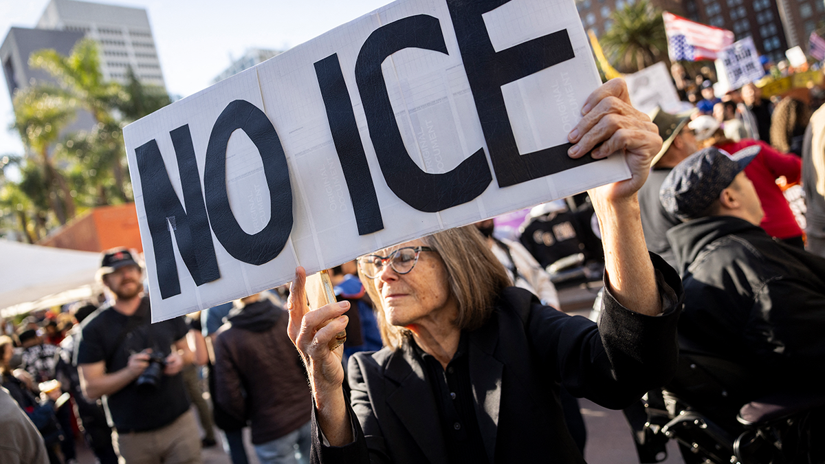 People hold signs as they protest in Los Angeles, California on January 10, 2026 against US Immigration and Customs Enforcement (ICE) after the fatal shooting of Renee Nicole Good in Minneapolis.