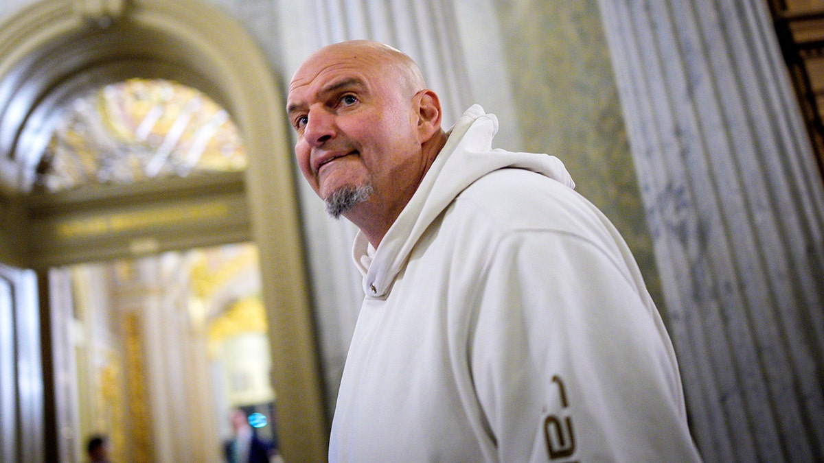 Sen. John Fetterman reacts as he arrives for votes on Capitol Hill