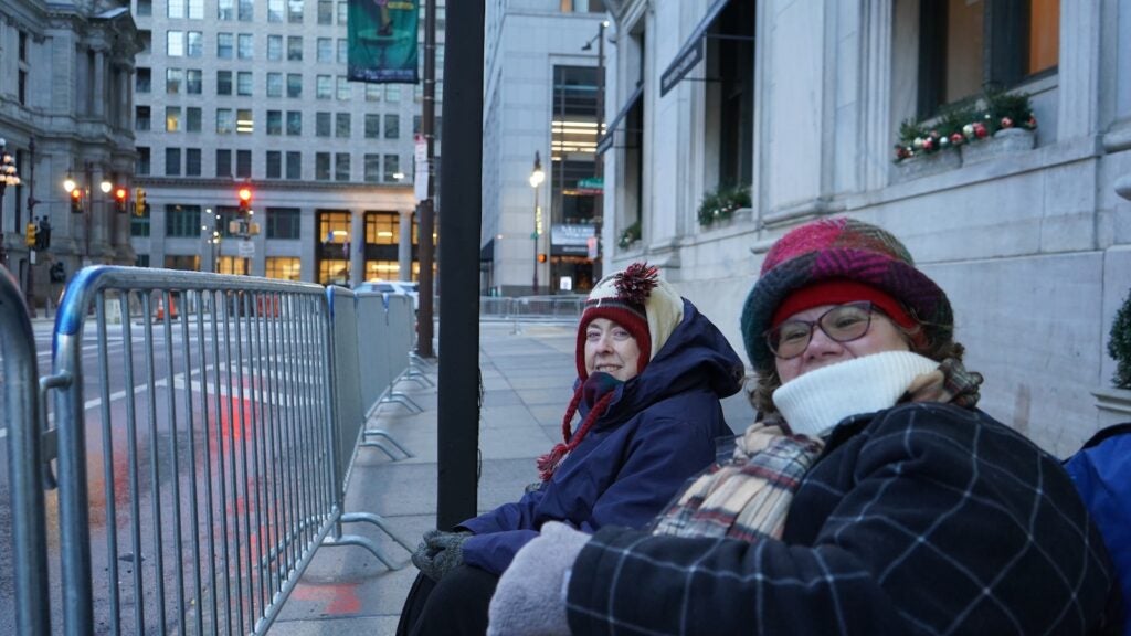 Kris Hines (right) and Melanie Thompson camped out on the sidewalk for the Philadelphia Mummers Parade on New Year's Day 2026